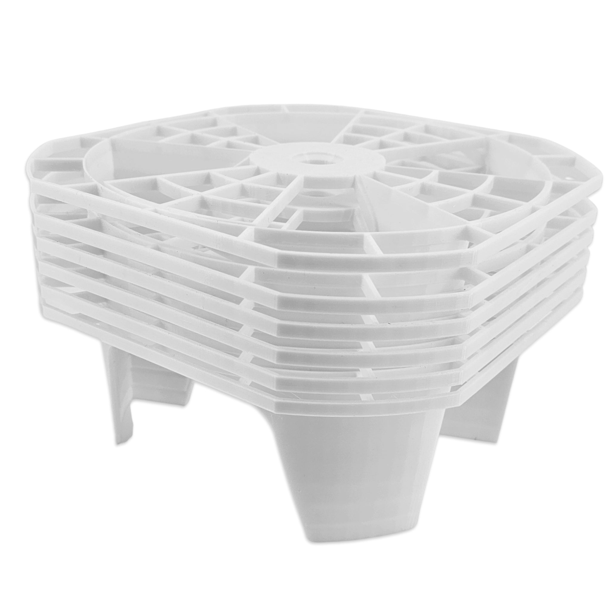 A stack of white plastic square risers or feet with a ribbed top and four short legs, shown on a plain white background.